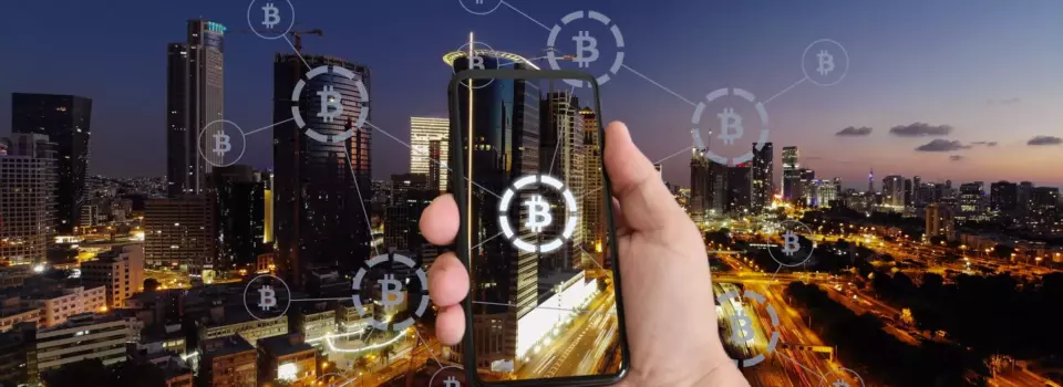 Bitcoin logo over a city skyline