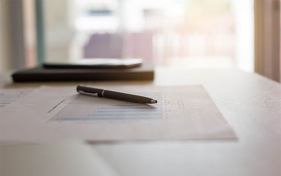 Pen on desk with chart printout