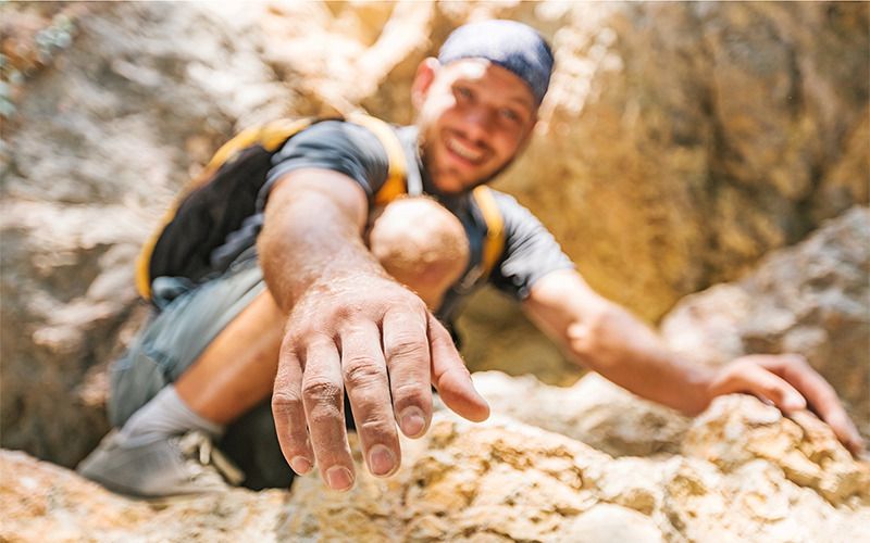 Hiker offering a hand up