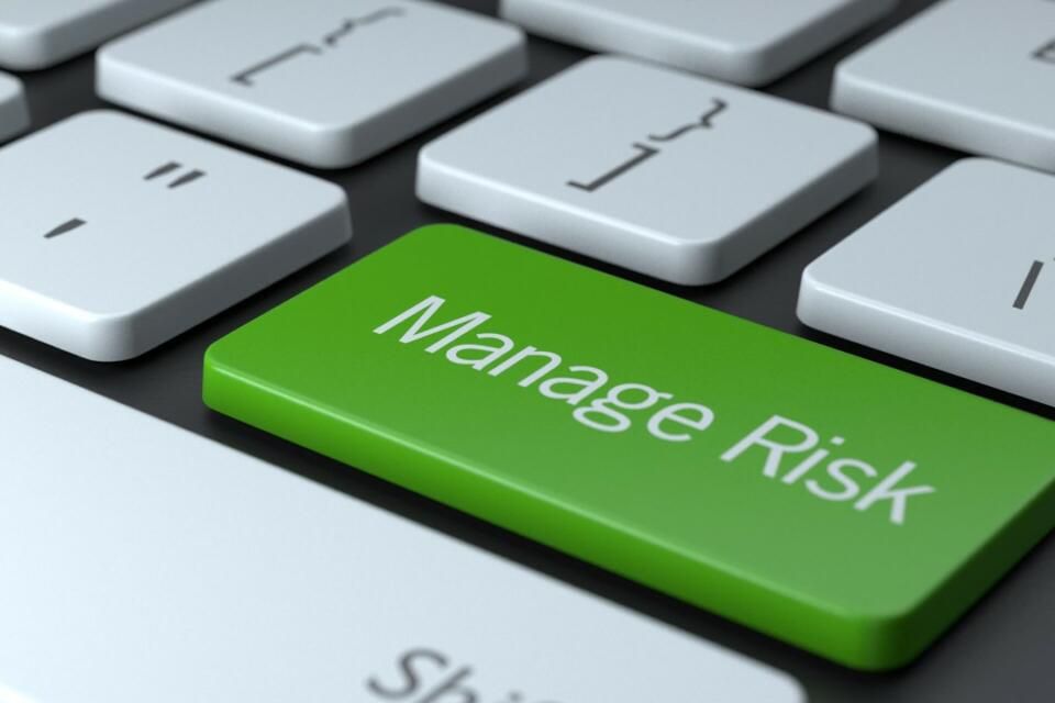 Green key on keyboard with text, "Manage Risk"