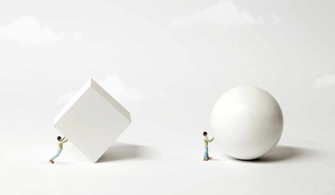 Figure pushing a square block and a sphere