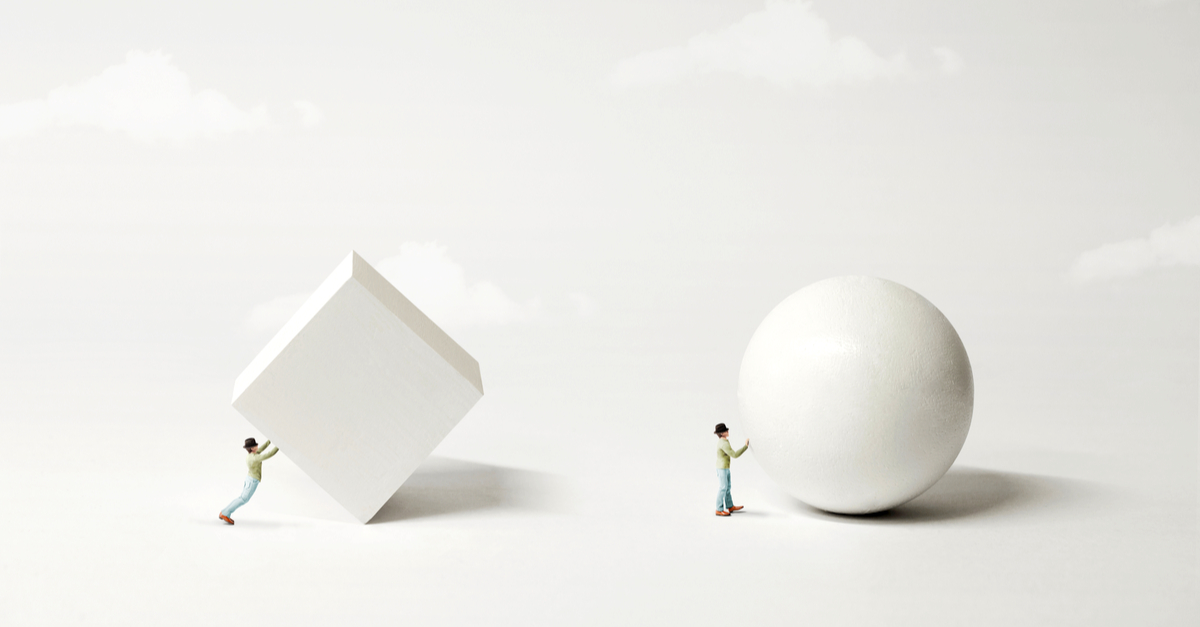 Small puppets of person pushing a block and pushing a sphere
